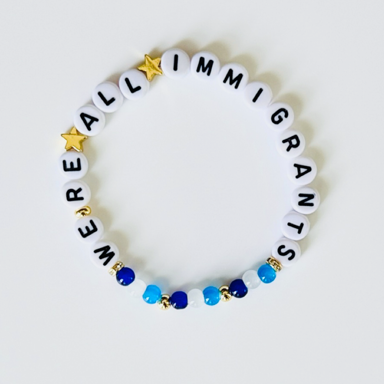 We’re All Immigrants Bracelet – Beaded Stretch Bracelet with Donation, Handmade Inclusion Gift for Justice and Solidarity