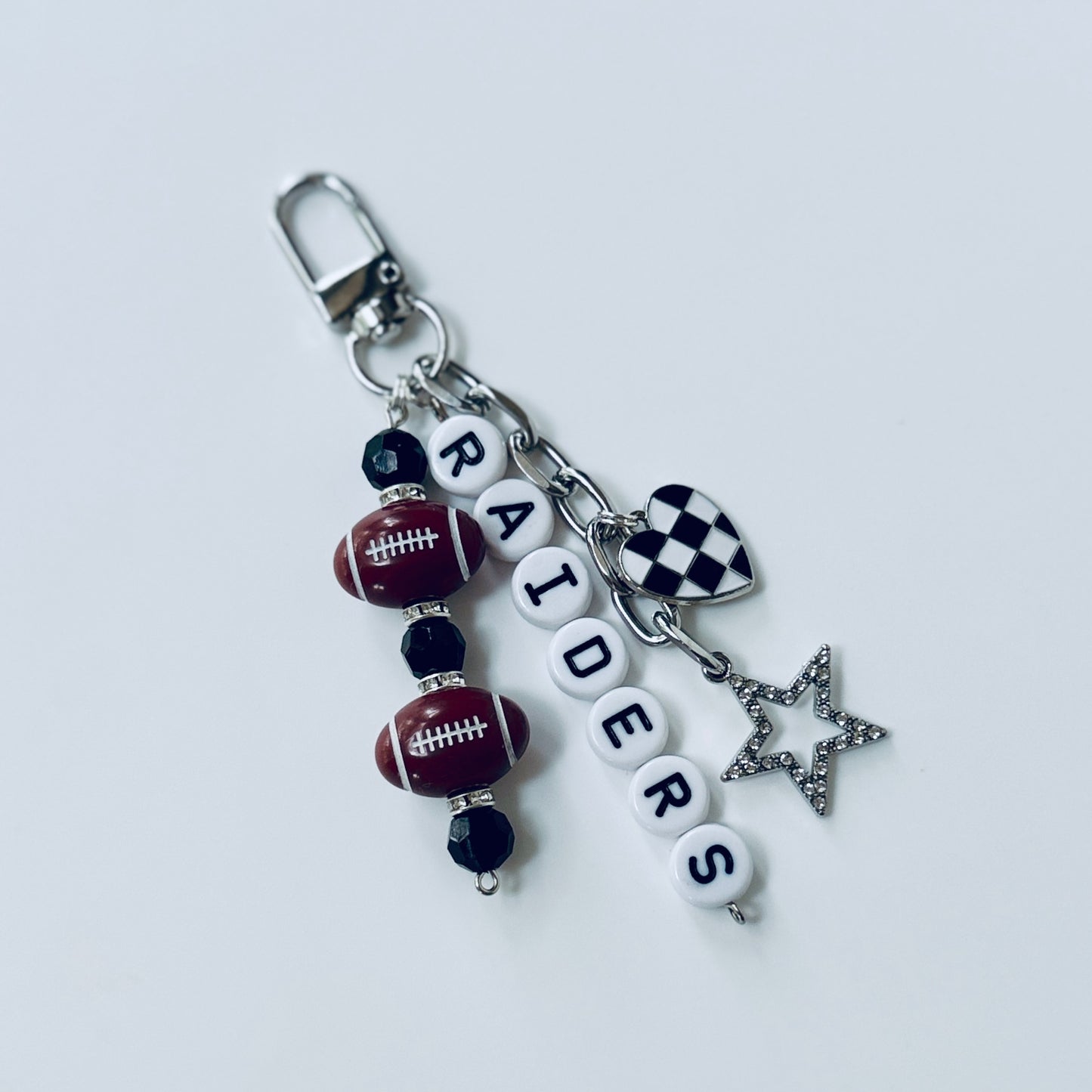 Raiders Football Beaded Keychain: Silver Bag Charm with Enamel Heart and Star