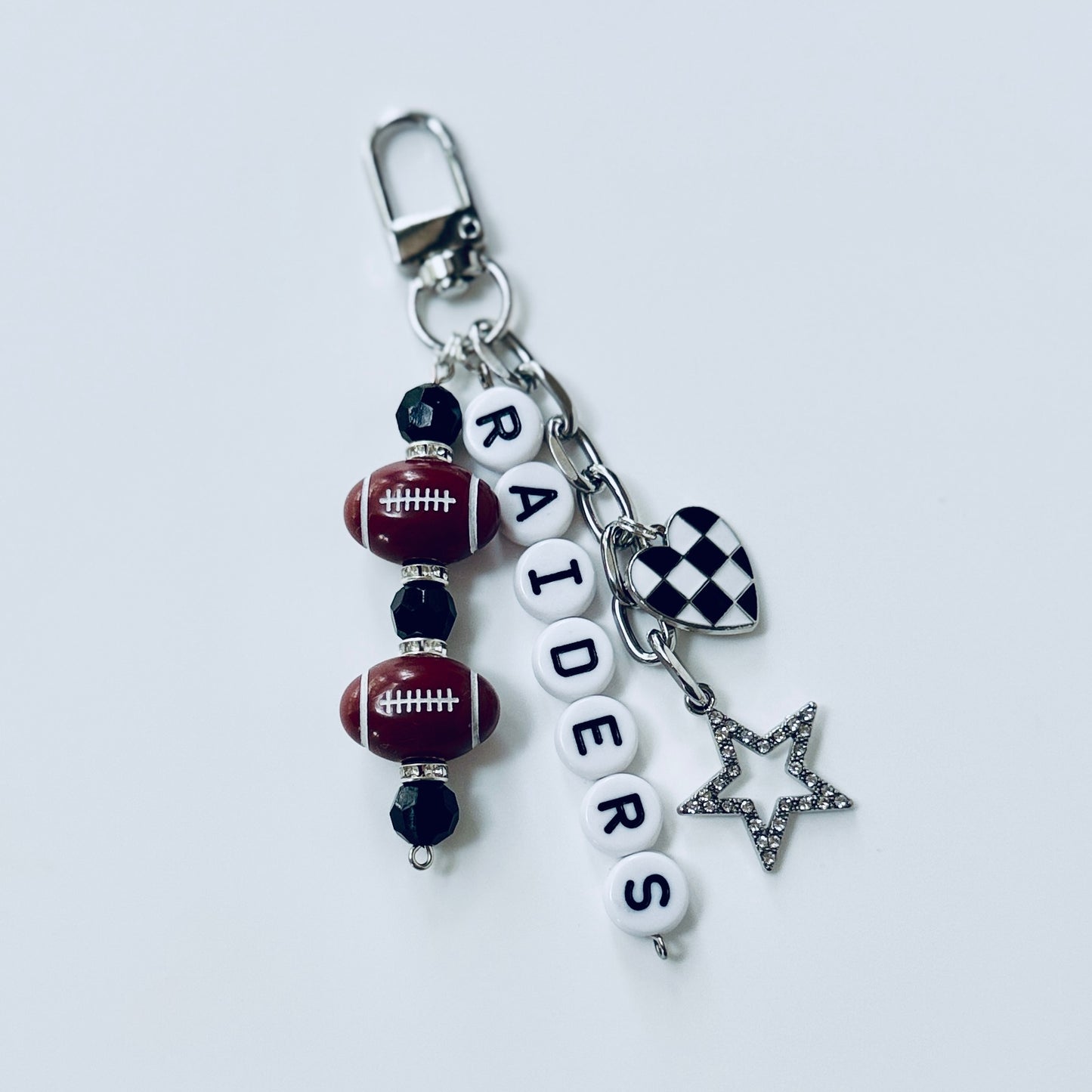 Raiders Football Beaded Keychain: Silver Bag Charm with Enamel Heart and Star