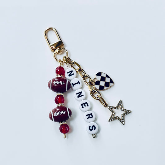 Niners Football Beaded Keychain: Gold Bag Charm with Enamel Heart and Star